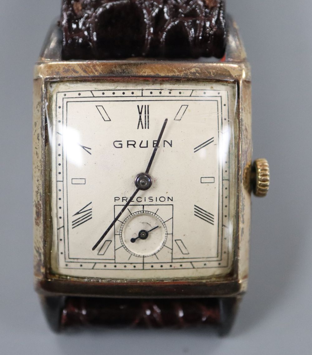 A gentlemans 1930s? 10k gold filled Gruen Precision manual wind wrist watch, with rectangular Roman and baton dial